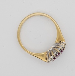 A ruby and diamond ring, designed as a lozenge-shaped cluster, set with four circular-cut rubies within a border of circular-cut diamonds, mounted in 18ct gold, size O, British hallmarks, gross weight 3 grams, Condition: